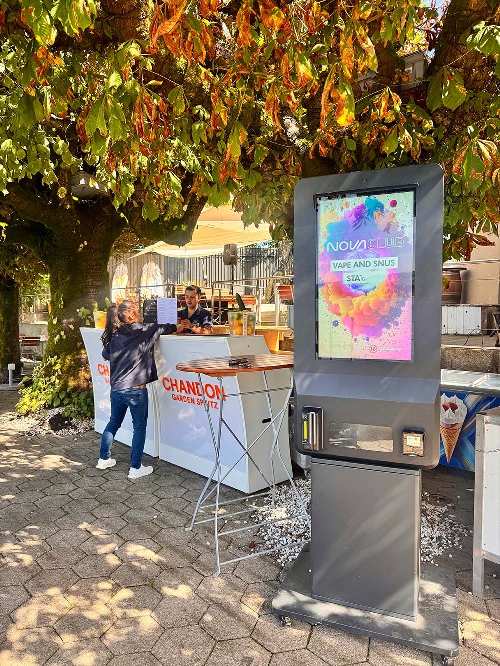Ein Gast an einem Nova Max neben einer Open-Air-Bar